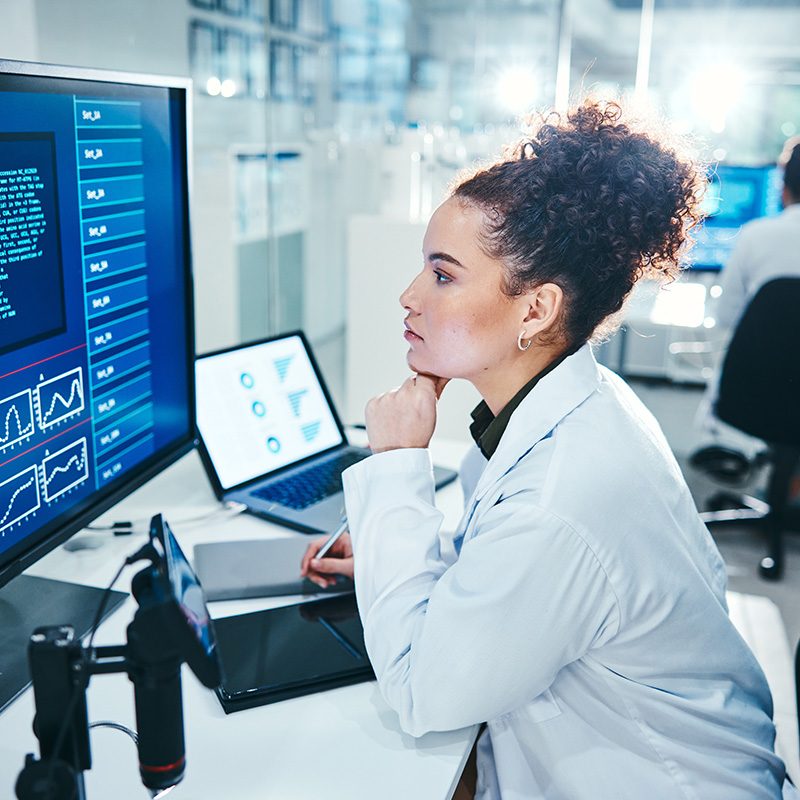 Computer, screen and scientist in laboratory with thinking, planning and analysis with medical rese.